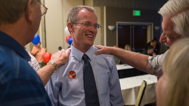
County Administrator Dean Cox, left, and Stephen Wade, right, congratulate Washington County Attorney Brock Belnap at a campaign party on Tuesday.
