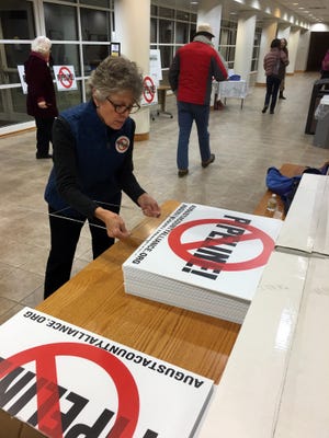 Susie Baker a volunteer with the Augusta County Alliance prepares signs to handout at the meeting at the Agusta County Center in Verona Wednesday, Jan. 20, 2016. 