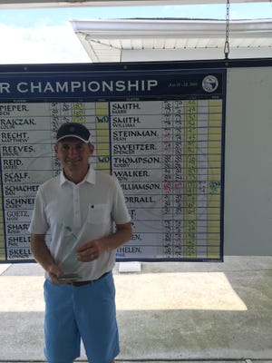 Bill Williamson holds the trophy he earned with his Northern Kentucky Amateur Championship win.