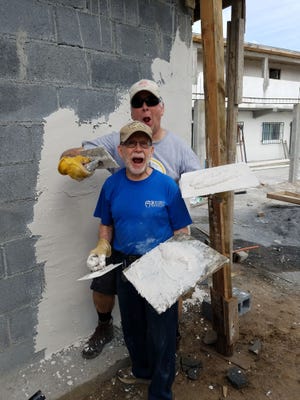 Basil Bloss (front) of Fowlerville and Brian Saunders of Highland work on a building in Rio Bravo, Mexico.