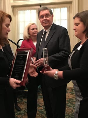 Jere Beasley, a senior member of the Beasley Allen Law Firm, stands with staff members after receiving the "Leading Workplace for Women" award from the Girl Scouts of Southern Alabama.