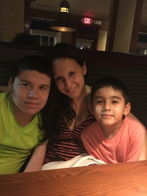 Marisol Santos with her two sons, Michael, left, and Ethan, right.