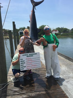 Tom and Michelle Serbin hold a 145-pound mako shark that they caught at the Baltimore Canyon.