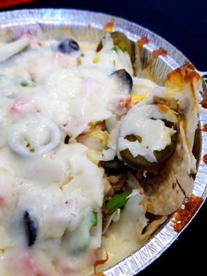 For a change of pace, try the Pizza Pub's deluxe nachos, with cheese sauce and mozzarella cheese, sausage, and your favorite vegetable pizza toppings.