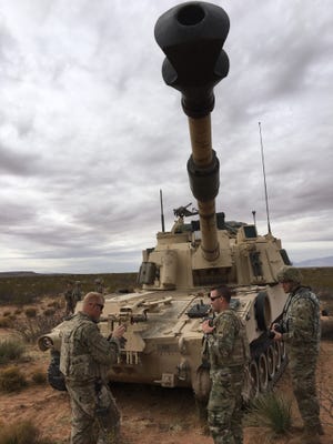 Soldiers with the 4th Battalion, 1st Field Artillery Regiment are participating in gunnery and in Bulldog Focus with 3rd Brigade. Here, soldiers stand in front of a Paladin, a mobile howitzer system.