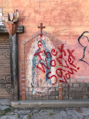 An unknown person or persons vandalized religious iconography with spray paint at Paintbrush Alley. Feb. 26, 2018.