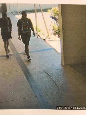 Surveillance video shows two suspects who police said burglarized an elementary school.