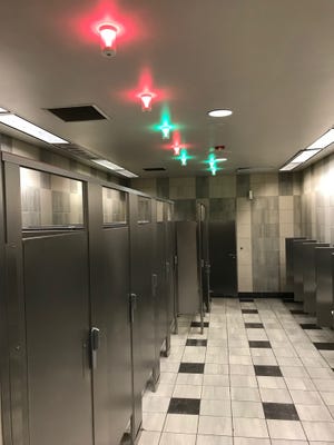 LAX will showcase technology that uses overhead lights to signal if a bathroom stall is occupied or not.