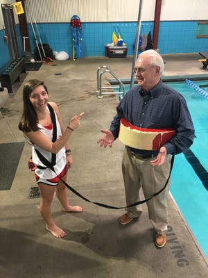 Mickey Griffin being roped in by East YMCA lifeguard Rachel Arnold.