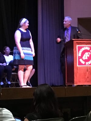 Menomonee Falls High School senior Jenna Lockwood (left) is presented with the first ever Young Rembrandts of Milwaukee high school scholarship May 30 from the Young Rembrandts of Milwaukee founder Don Eisenhauer (right).