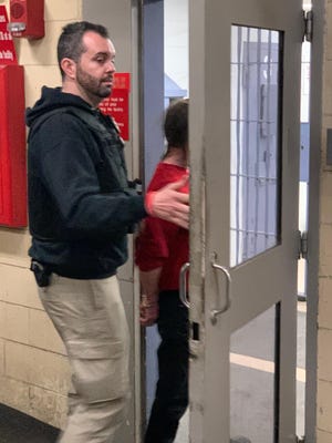 Franklin County Municipal Probation officer Ben Nicholas, left, escorts a domestic violence offender into the Franklin County Jail after arresting him as a member of the High Risk Domestic Violence team. Nicholas and Columbus police officer Anthony Roberts, along with a team, meet with offenders and victims in the community to provide support, resources and enforcement.