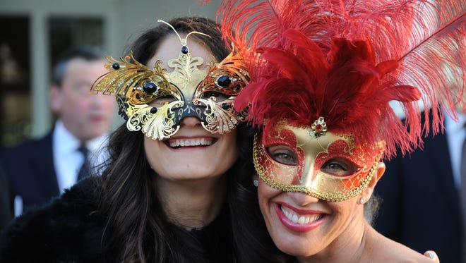 Maria Santana, left, and Jovanna Stepan don masks for Winnakee Land Trust's annual gala May 20 in Rhinebeck.