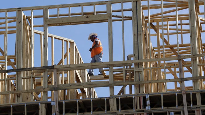 In this Oct. 6, 2017, file photo, workers build an apartment and retail complex in Nashville, Tenn. U.S. economic growth in the first quarter was revised down to a lackluster 2 percent, a sharp deceleration and the poorest showing in a year. But economists expect a significant rebound in the current quarter, forecasting a sizzling growth rate of 4 percent or more.
