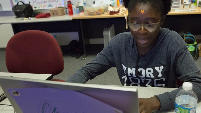 Christa Attiogbe,15, works on coding a website designed about disease and poverty prevention, during the Young Women in Computing (YWiC), alumni camp, Wednesday, June 7, 2017 at New Mexico State University.
