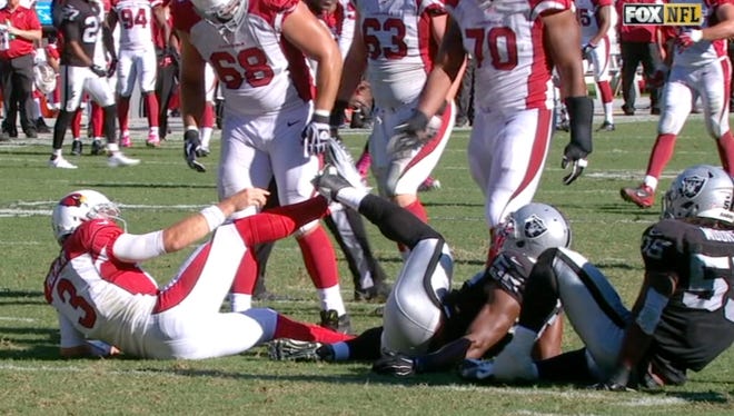 Carson Palmer and Khalil Mack got their cleats stuck together.