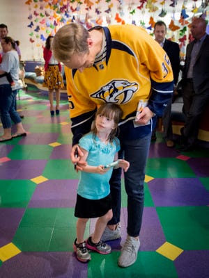 Predators goalie Pekka Rinne greets patient Annie Milan, 6, at the Monroe Carell Jr. Children's Hospital's Seacrest Studios on Monday.