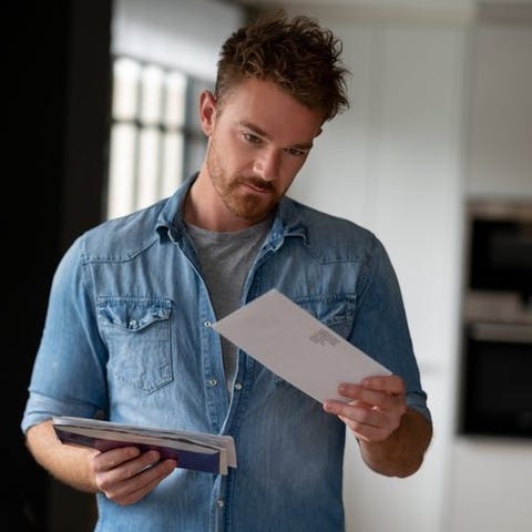 A man standing in his living room and holding a pi