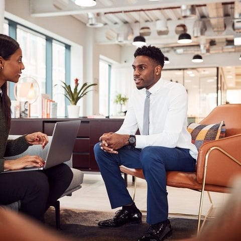 A woman asking a man questions in a job interview 