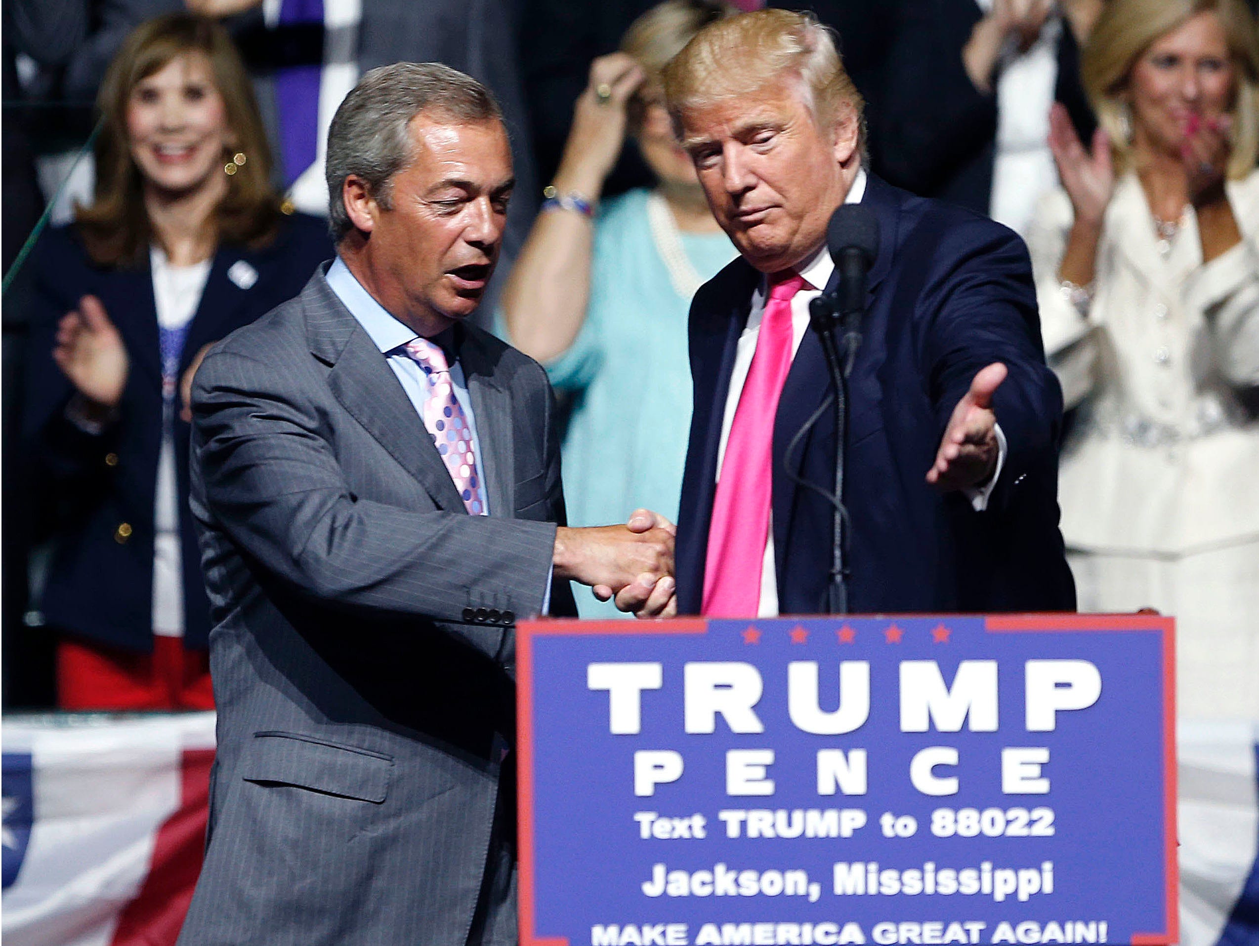In this Wednesday, Aug. 24, 2016, file photo, then-Republican presidential candidate Donald Trump, right, welcomes pro-Brexit British politician Nigel Farage, to speak at a campaign rally in Jackson, Miss.
