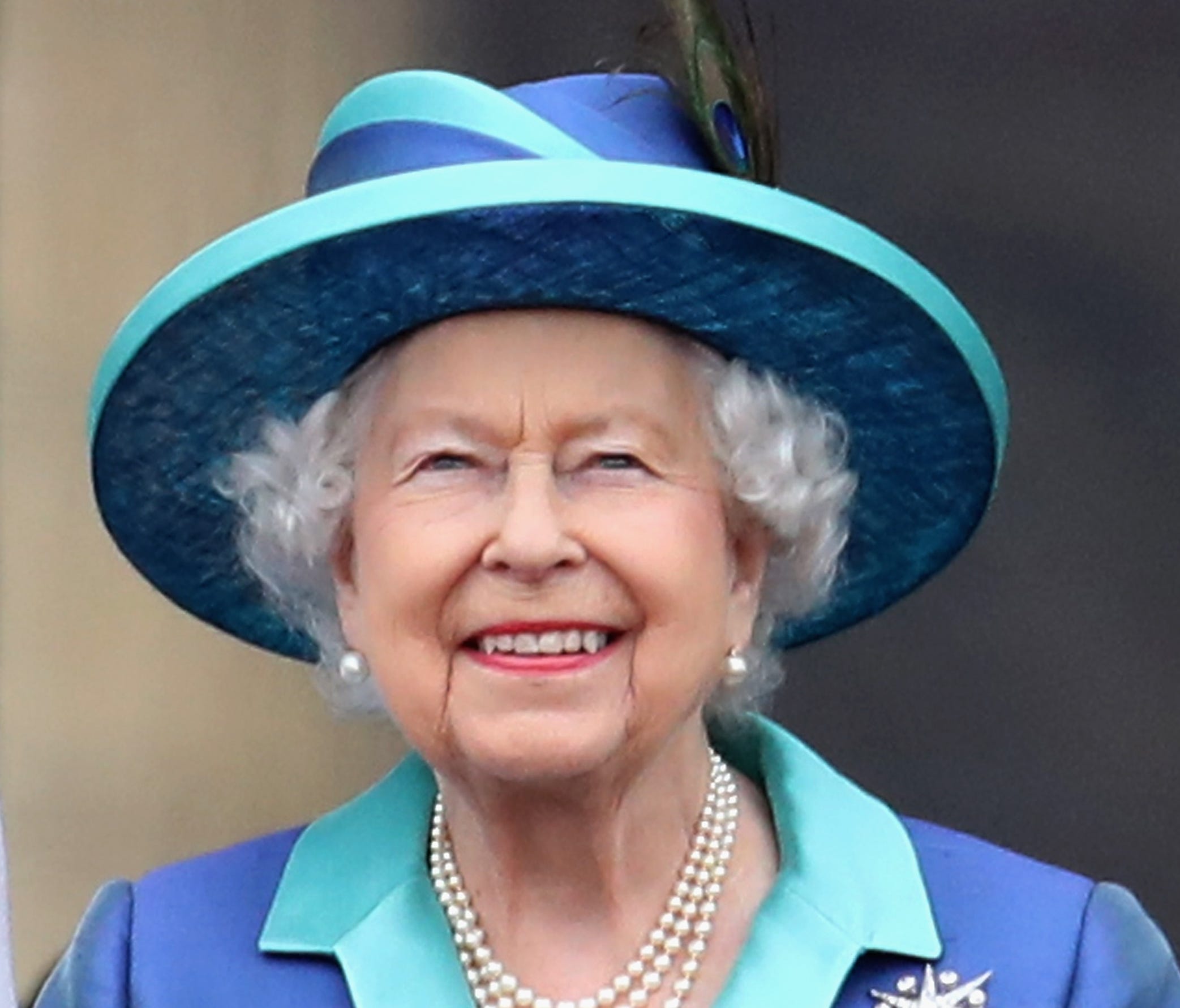 Queen Elizabeth II watches the Royal Air Force fly past the balcony of Buckingham Palace, as members of the Royal Family attend events to mark the centenary of the RAF on Tuesday in London.