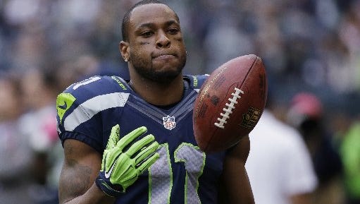 In this Oct. 12, 2014, photo, Seattle Seahawks wide receiver Percy Harvin stands on the sideline late in the second half of the Seahawks' 30-23 loss to the Dallas Cowboys in an NFL football game in Seattle. The New York Jets have acquired Harvin from the Seahawks. Two people familiar with the trade told The Associated Press on Friday, Oct. 17, 2014, that Harvin, a star in last season's Super Bowl but injury-prone through his career, was headed to the Jets. The people spoke anonymously because the deal was not officially announced by either club.