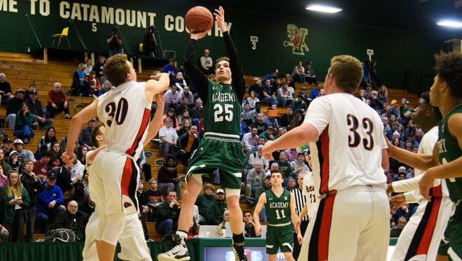 St. Johnsbury's Logan Wendell (25) shoots the ball over Rutland's Ethan Notte (30) during the Division I boys basketball semifinal game between the St. Johnsbury Comets and the Rutland Raiders at Patrick Gym on Thursday night March 15, 2018 in Burlington.