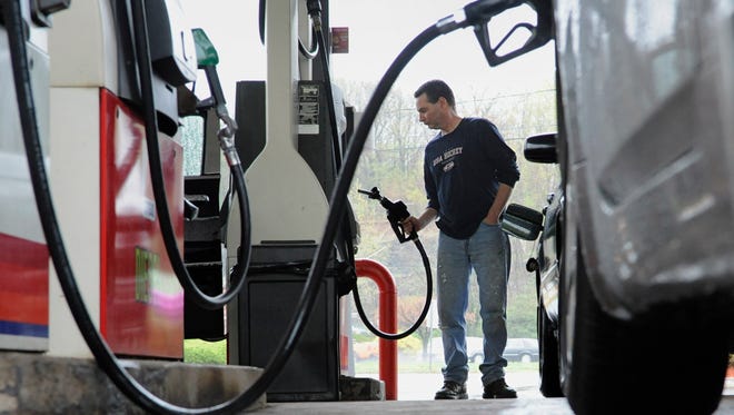 John Magel pumps gas at a station in Wethersfield, Conn., in this 2011 file photo