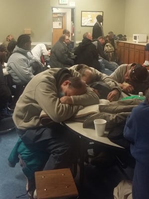 A photo provided by a client at the Volunteers of America homeless shelter on Record Street shows homeless people sleeping on tables and chairs after the overflow shelter was shut down. According to photo data this was taken Feb. 22, 2016 at 4:47 a.m.