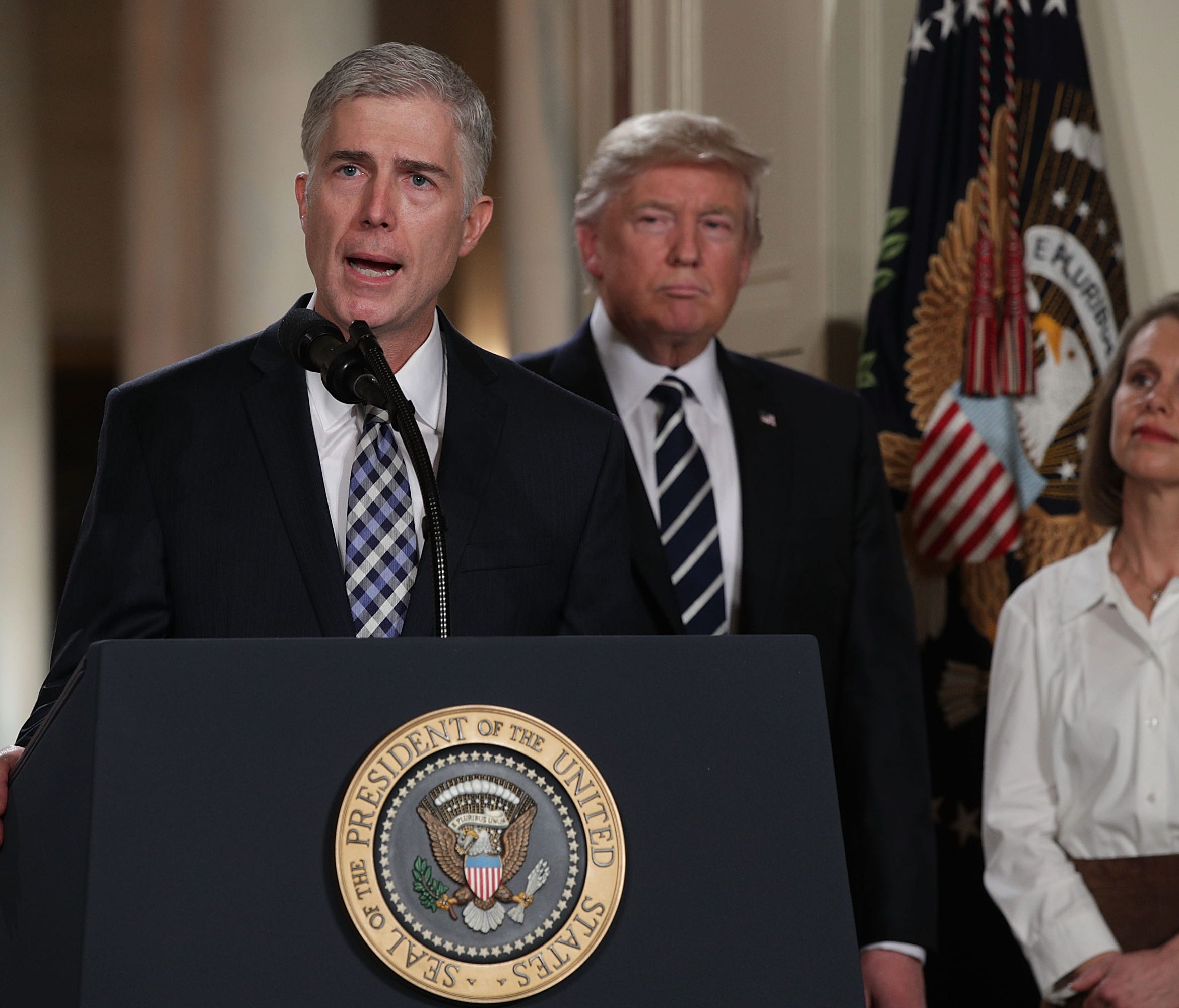 Judge Neil Gorsuch speaks to the crowd as his wife, Louise, looks on after President Trump nominated him to the Supreme Court during a ceremony in the East Room of the White House on Jan. 31, 2017.