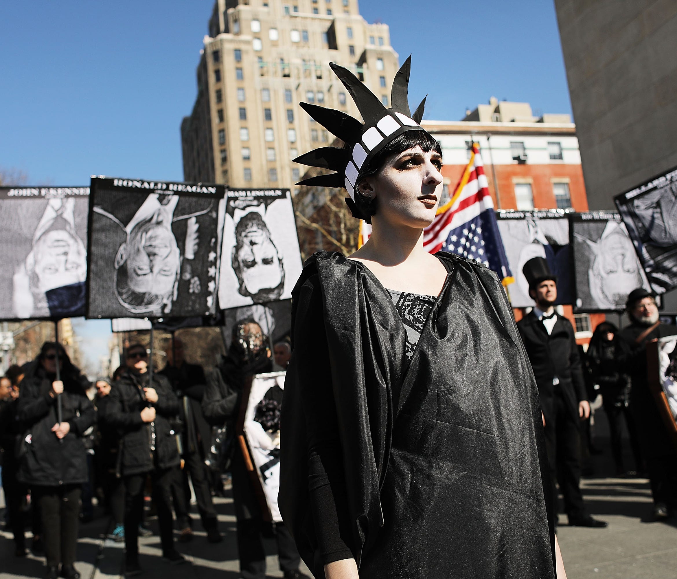 People attend a rally and a mock funeral for the presidency Saturday in New York.