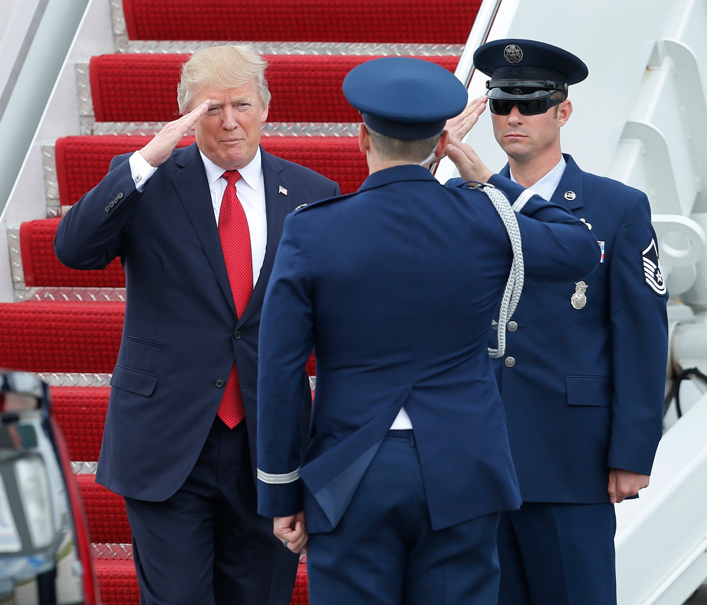 President Trump salutes upon his arrival on Air Force One at Palm Beach International Airport in West Palm Beach, Fla., Thursday.