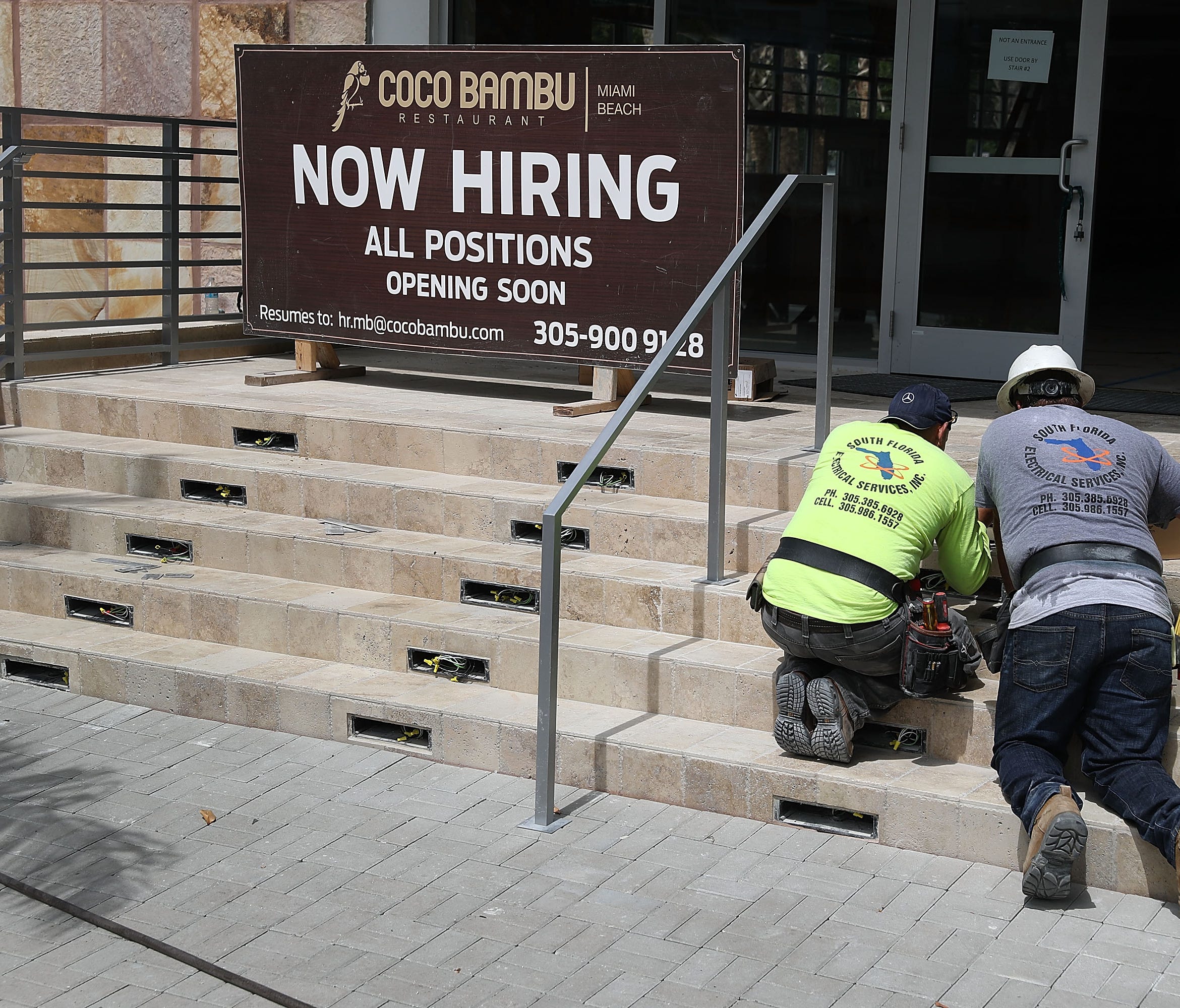 MIAMI, FL - JULY 07:  A now hiring sign is seen on the steps of a business as workers prepare the building for the new restaurant on July 7, 2017 in Miami, Florida. The U.S. Labor Department  on Friday is expected to report 180,000 job gains in July,