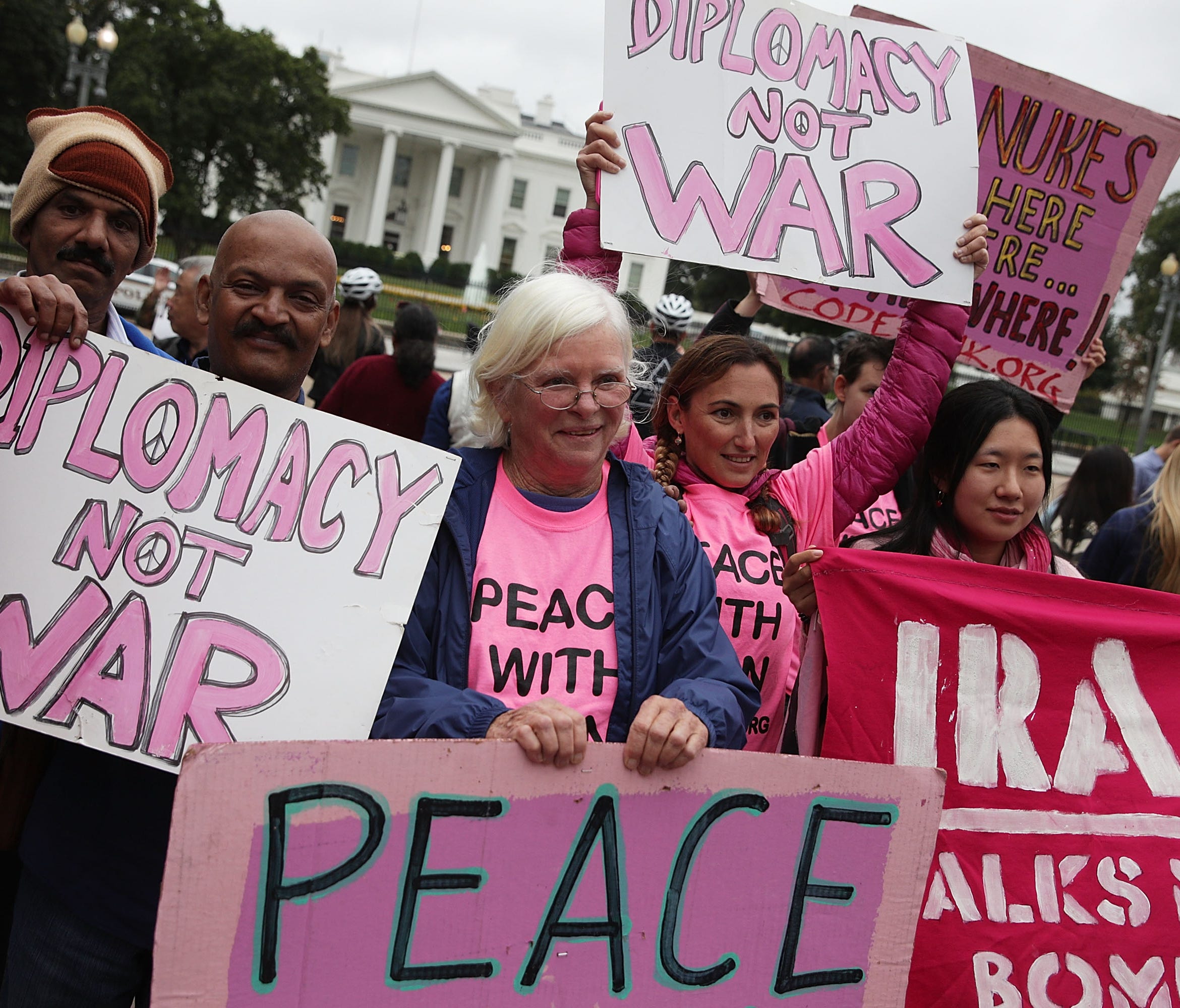 Activists are pictured outside the White House holding a rally denouncing President Trump's anticipated decision to de-certify the Iran nuclear deal.