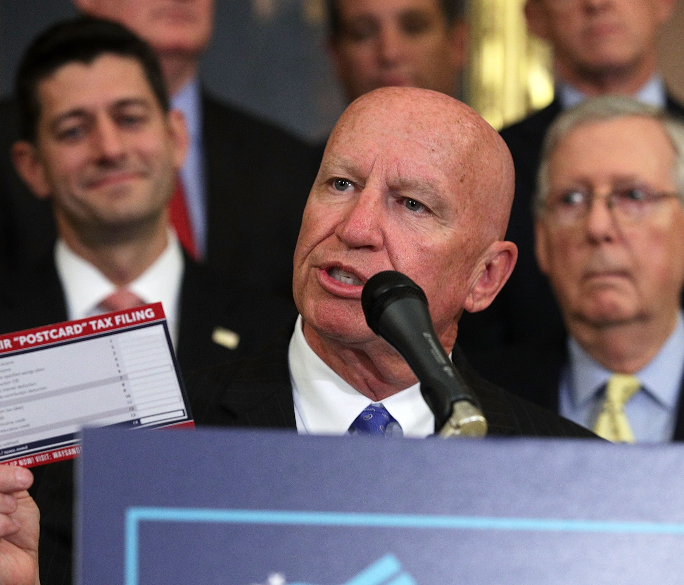 Rep. Kevin Brady holds up a tax filing 