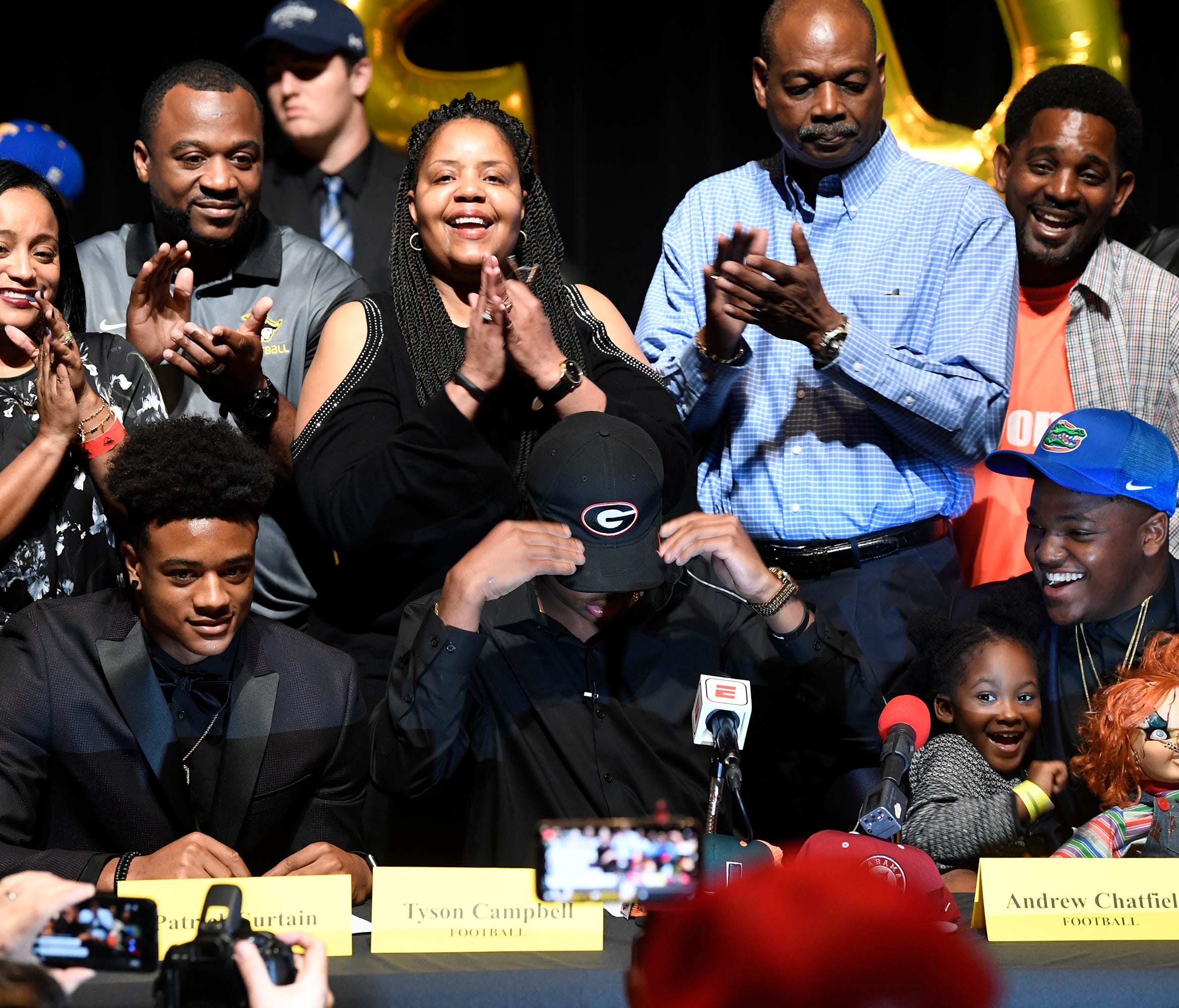 Tyson Campbell of American Heritage High School puts on a Georgia hat after announcing his is signing with the Bulldogs.
