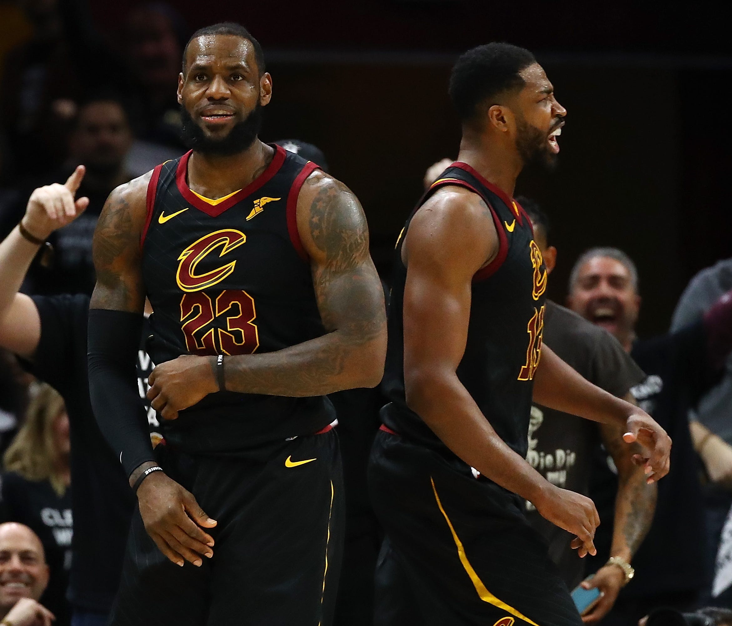 LeBron James #23 and Tristan Thompson #13 of the Cleveland Cavaliers react to a second half play while playing the Indiana Pacers in Game Seven of the Eastern Conference Quarterfinals during the 2018 NBA Playoffs at Quicken Loans Arena on April 29, 2