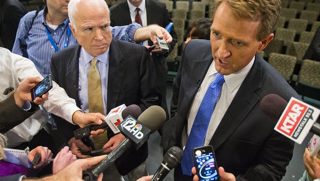 Sen. John McCain (left) and Sen. Jeff Flake answer questions at the conclusion of the Conversation On Immigration forum on Aug. 27, 2013, at the Mesa Arts Center.