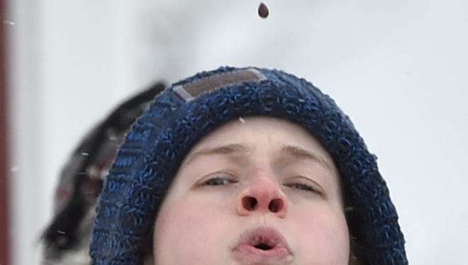 Lizzy Peters of Appleton lets one fly during the cherry pit spit competition at a Winter Wine & Cherry Fest at Lautenbach's Orchard Country Winery and Market in Fish Creek.