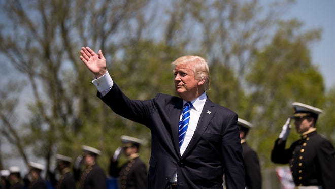 President Donald Trump waves as he prepares to exit the commencement ceremony for the U.S. Coast Guard Academy, May 17, 2017 in New London, Connecticut.