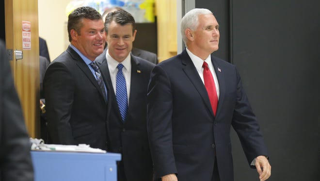 United States Vice President Mike Pence, right, tours the TKO Graphix facility with CEO Tom Taulman II, left, and U.S. Sen. Todd Young, R-Ind., center, Plainfield Ind. on Thursday, Nov. 9, 2017.