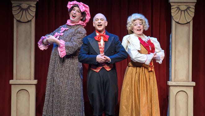 Nathan Marinan (left), Chris Flieller and Elyse Edelman make merry in "Scrooge in Rouge," performed by In Tandem Theatre.