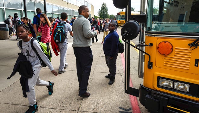 Principal Jason Harris talks with students as they head to their buses Thursday, Sept. 28, at South Junior High School. Enrollment in the St. Cloud school district is up nearly 3 percent, an increase of more than 250 students.