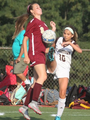 Clarkstown South's Danielle McManus, right, tries to play the ball past Arlington's Emma Sbrollini during their game at Clarkstown South on Tuesday.