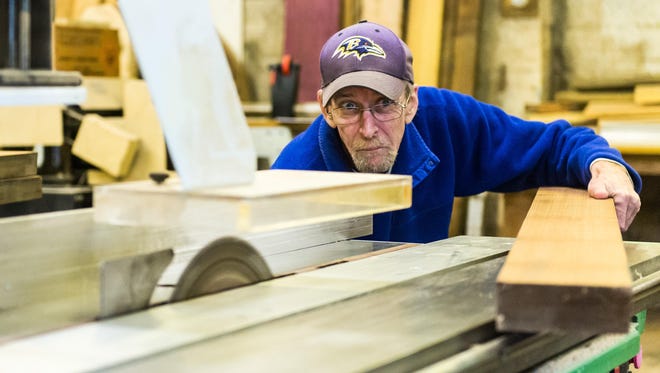 Don McCready cuts a piece of salvaged wood at Chesapeake Woodworkers Sales in Millsboro.