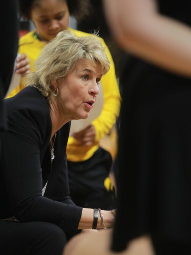Iowa head coach Lisa Bluder talks to her team during
