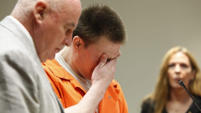 Clayton Whittemore, center, wipes away tears before his sentencing at the Hall of Justice in Rochester on Aug. 5, 2014.