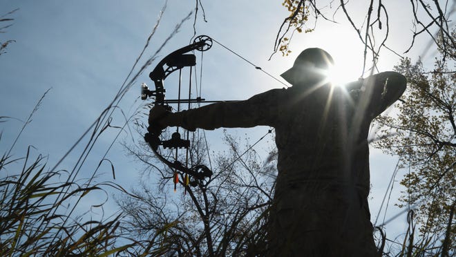 Bow Hunter Aiming Compound Bow