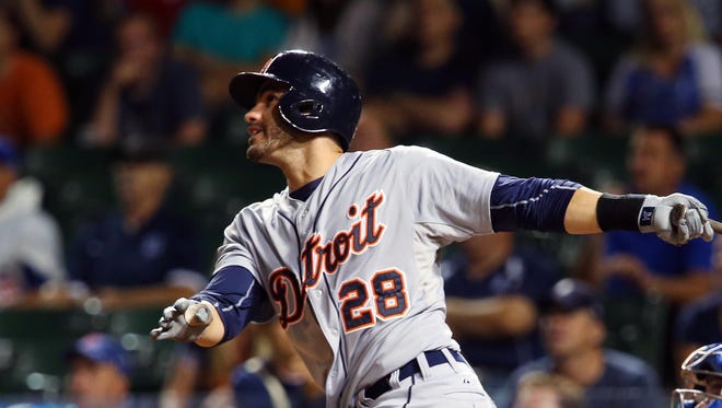 Aug 18, 2015; Detroit Tigers right fielder J.D. Martinez drives in a run with a sacrifice fly against the Chicago Cubs during the eighth inning at Wrigley Field.