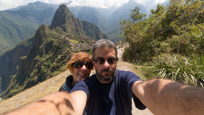 Tourists take a selfie on the terraces above Machu Picchu, the most visited travel destination in Peru.