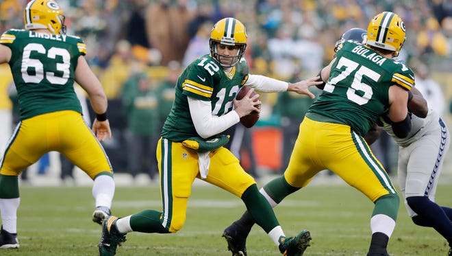 Green Bay Packers quarterback Aaron Rodgers (12) changes direction in the pocket in the first quarter against the Seattle Seahawks as the Green Bay Packers host the Seattle Seahawks on Sunday, December 11, 2016, at Lambeau Field in Green Bay, Wis.